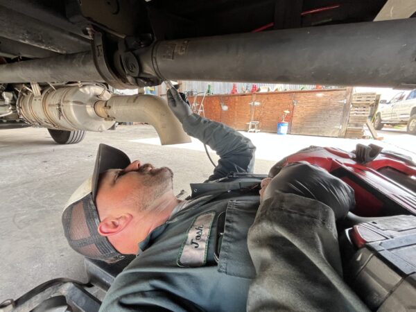Mechanic apply axle grease as a preventative maintenance measure.